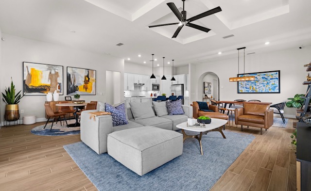Open-plan new-build interior with layered seating and dining beyond